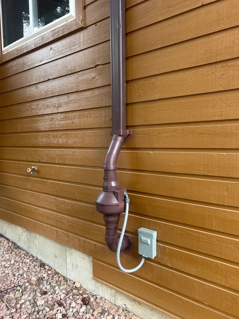 Radon fan and downspout transition finished in Royal Brown to match the home