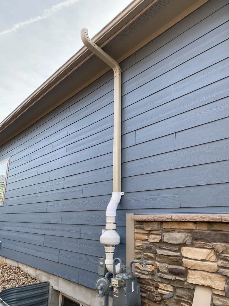 Radon mitigation system with two-tone downspout installation